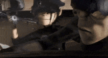 a man and a woman are standing next to each other in a car and the woman is holding a gun .