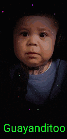 a baby 's face is in a blue cube with the words guayanditoo written on it