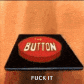 a red button with the words `` button '' written on it is sitting on a wooden table .