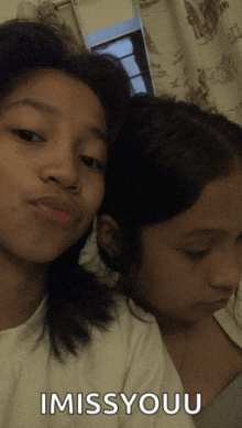 two girls are posing for a picture and the caption imissyouu is on the bottom