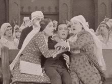 a black and white photo of a group of people including a man