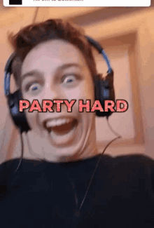 a man wearing headphones with the words party hard written on his face