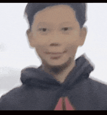 a blurry picture of a boy wearing a hoodie