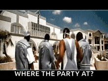 a group of men are standing in front of a building with the words " where the party at " on the bottom