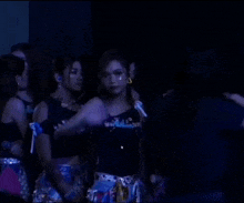a group of women are standing in a dark room and the word bye chat is on the bottom