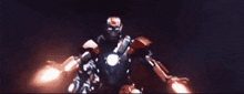 a group of iron man suits are flying in the air .