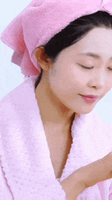 a woman with a pink towel on her head