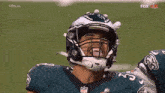 a football player wearing a helmet that has the number 23 on it