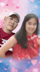 a man and a woman are posing for a picture and the man is wearing a hat that says ' hal ' on it