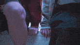 a person holding another person 's hand while standing on stairs