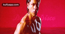 a man without a shirt is standing in front of a red background with the words kulfyapp.com at the top