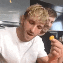 a man is holding a piece of food in his hand .