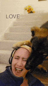 a woman with headphones and a dog licking her face with the word love behind her