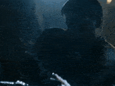 a man and a woman are kissing in the dark