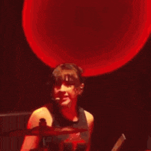 a woman with red hair is holding a drum stick in front of her face .