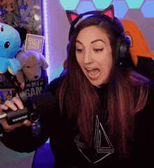 a woman wearing headphones and a shure microphone