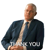 a man in a suit and tie says thank you with his hands folded