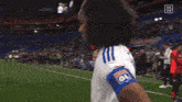 two female soccer players on a field with da zn in the corner