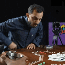 a man playing a game with a camera on a tripod that says nikon