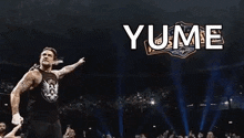 a man in a black tank top is standing in front of a sign that says yume on it