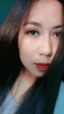 a close up of a woman 's face with long black hair