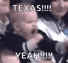 a baby is crying in a crowd with the words texas yeah written on it