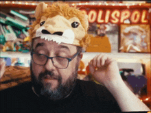 a man wearing a lion mask and glasses stands in front of a sign that says polispol