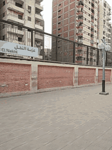 a brick wall with a blue sign that says ' eeu ' on it
