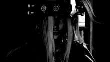 a black and white photo of a woman 's face with a necklace around her neck