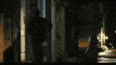 a man and a woman are standing in front of a door at night