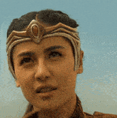 a close up of a woman 's face with a crown on her head that says ' a ' on it