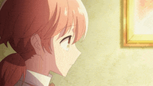 a close up of a girl 's face with a picture behind her