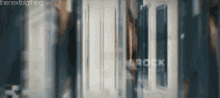 a blurred image of a hallway with the word rock written on the wall