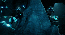 a group of robots are standing in a dark cave
