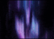 a person standing in a dark room with a purple light behind them