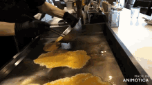 a person is cooking food on a griddle with the words made in animotica on the bottom right
