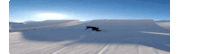 a snowboarder is doing a trick on a snow ramp