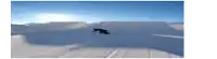 a snowboarder is doing a trick on a snow ramp