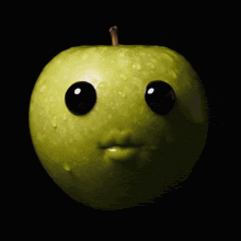 a green apple with googly eyes and a face on it