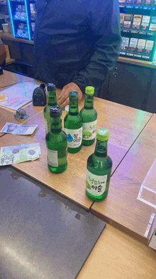 several bottles of alcohol are on a table and one of them has a label that says ' korean ' on it