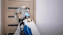 a woman in a cosplay costume is standing in a doorway .