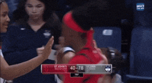 a basketball game between st john 's red storm and uconn huskies is being played