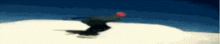 a person is snowboarding down a snow covered slope .
