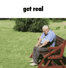 an elderly man is sitting on a wooden bench in a park with the words `` get real '' above him .