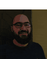 a man with glasses and a beard has the word brilliance written on his face