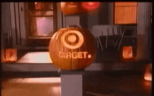 a target pumpkin is sitting on top of a pillar in front of a store .