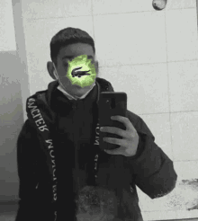 a man is taking a selfie with a mask on his face