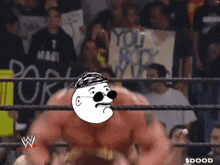 a man in a wrestling ring with a sign that says " you rock " in the background