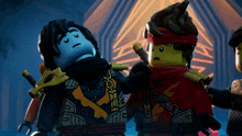 two lego figures are standing next to each other and one of them has a scarf around his neck