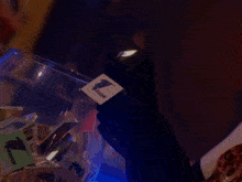 a man is lighting a candle in front of a woman in a dark room